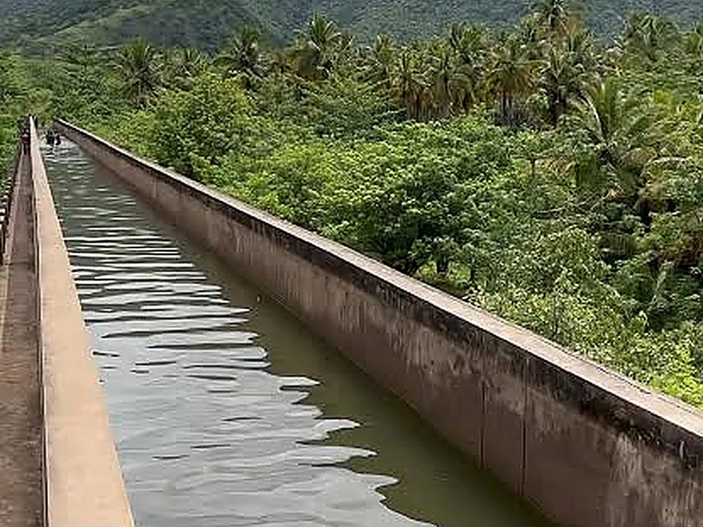 Cumbum Thottipalam, Theni – water channel with Western Ghats mountains behind